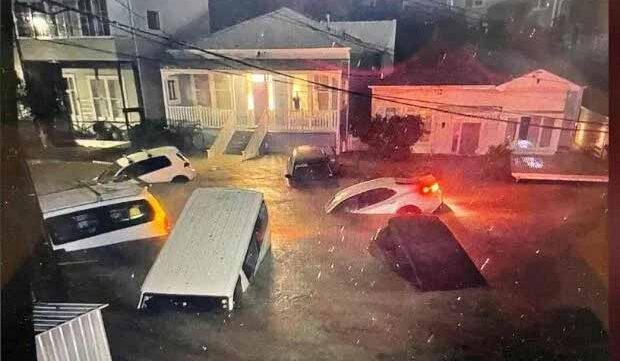 Cars submerged in floodwater in a Wellington residential street after heavy rain