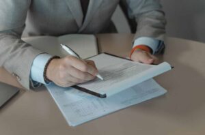 Home buyer reviewing mortgage documents and debt-to-income requirements before applying for a home loan