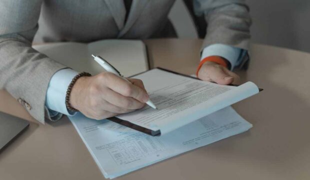 Home buyer reviewing mortgage documents and debt-to-income requirements before applying for a home loan