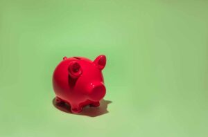 Red piggy bank representing KiwiSaver savings for a first-home deposit in New Zealand