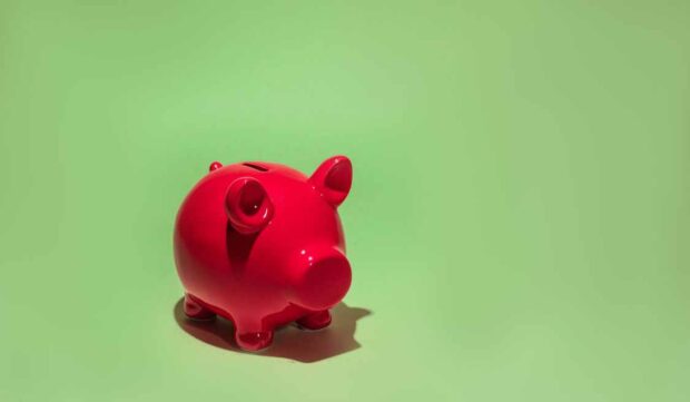 Red piggy bank representing KiwiSaver savings for a first-home deposit in New Zealand